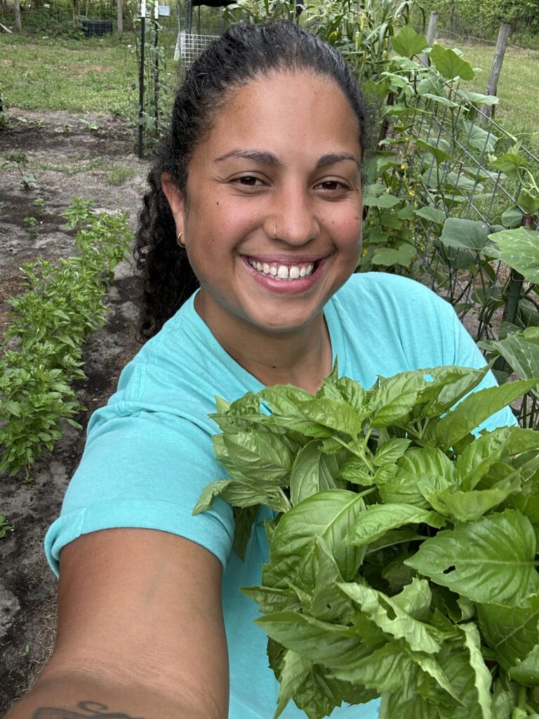 vanessa with basil in the garden